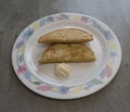 Fried chebureks with mayonnaise on a plate with patterns on the table