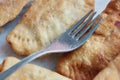 Fried chebureks on the table close-up fork lies on top