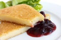 Fried cheese, cut and melting with cranberry sauce.