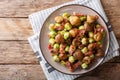 Fried chestnuts, brussels sprouts and bacon closeup. horizontal