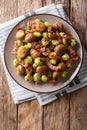 Fried chestnuts, brussels sprouts and bacon closeup. Vertical to