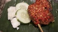 Fried chicken with Balado sauce and some veggie made by stir frying ground red hot chili pepper including garlic, shallot, tomato Royalty Free Stock Photo