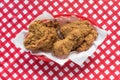 Fried chicken basket on red checkerboard tablecloth in center