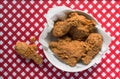 Fried Chicken basket on red and white checkered table with drumstick