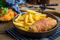 Fried chicken breast stuffed with mushrooms and cheese wrapped in ham served with fries and salad Royalty Free Stock Photo