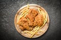 Fried chicken crispy on wooden tray with french fries on dark background Royalty Free Stock Photo