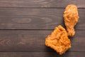 Fried chicken drumstick and chicken breast on the wooden background. Copyspace for your text