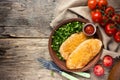 Fried chicken fillet with cheese crust and garnish of fresh vegetables, healthy food Royalty Free Stock Photo