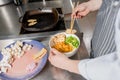 Fried chicken fillet is put on plate. Chef cooks spaghetti noodles for ramen soup. Cooking ramen soup with meat Royalty Free Stock Photo