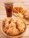 Fried chicken, french fries and soft drink on wooden table