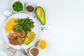 Fried chicken, fresh avocado and string beans on a white flat plate on a light background. Royalty Free Stock Photo