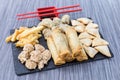 Fried chicken, gyozas, french fries, meat and mushrooms balls on a wooden table