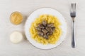 Fried chicken hearts and pasta, bowls with mustard, mayonnaise