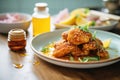 fried chicken with honey drizzle and biscuits Royalty Free Stock Photo