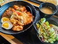 Fried Chicken Karaage Don served with white rice, curry, two half boiled eggs, salad and miso soup on a table. Royalty Free Stock Photo