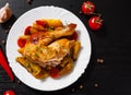 Fried chicken legs with carrots, onions and potatoes served on a white plate Royalty Free Stock Photo