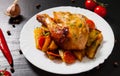 Fried chicken legs with carrots, onions and potatoes served on a white plate Royalty Free Stock Photo