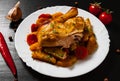 Fried chicken legs with carrots, onions and potatoes served on a white plate Royalty Free Stock Photo