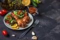 Fried chicken legs and fresh salad on a dark background Royalty Free Stock Photo