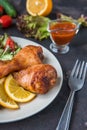 Fried chicken legs and fresh salad on a dark background Royalty Free Stock Photo