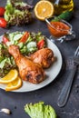 Fried chicken legs and fresh salad on a dark background Royalty Free Stock Photo