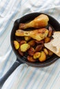 Fried chicken legs and fried potatoes in frying pan Royalty Free Stock Photo