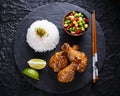 Fried chicken legs with teriyaki sauce sesame seeds and rice on black stone Royalty Free Stock Photo