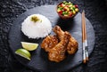 Fried chicken legs with teriyaki sauce sesame seeds rice on black stone Royalty Free Stock Photo