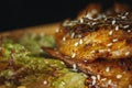 Fried chicken legs with teriyaki sauce sesame seeds and rice on black stone. Close up. Black background Royalty Free Stock Photo