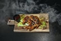 Fried chicken legs with teriyaki sauce sesame seeds and rice on black stone. Close up. Black background Royalty Free Stock Photo