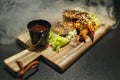 Fried chicken legs with teriyaki sauce sesame seeds and rice on black stone. Close up. Black background Royalty Free Stock Photo