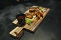 Fried chicken legs with teriyaki sauce sesame seeds and rice on black stone. Close up. Black background Royalty Free Stock Photo