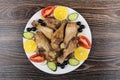 Fried chicken legs with vegetable, black olives and lemon Royalty Free Stock Photo