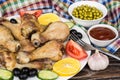 Fried chicken legs with vegetable, olives and lemon, garlic Royalty Free Stock Photo