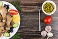 Fried chicken legs with vegetable, olives and lemon on table Royalty Free Stock Photo