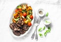 Fried chicken liver and baked seasonal vegetables - delicious healthy lunch on light background, top view