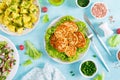 Fried chicken meat cutlets, fresh vegetable salad with radish, lettuce and cucumber, boiled new potato with butter, dill and green Royalty Free Stock Photo