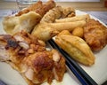 Fried Chicken, Nems and Samosa on a Full Plate: An Asian Culinary Delight with Chopsticks