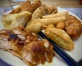 Fried Chicken, Nems and Samosa on a Full Plate: An Asian Culinary Delight with Chopsticks