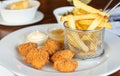 Fried chicken nuggets with french fries serve on white plate Royalty Free Stock Photo