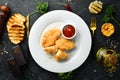Fried chicken nuggets with ketchup sauce on a plate. Royalty Free Stock Photo
