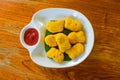 Fried chicken nuggets And tomato sauce on a white plate on a woo Royalty Free Stock Photo