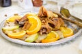 Fried chicken with orange and apples slices is on the platter Royalty Free Stock Photo