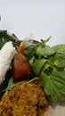 fried chicken pecel rice with spicy soy sauce sauce and grated coconut