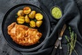 Fried Chicken schnitzel with baked potatoes. Black background. Top view Royalty Free Stock Photo