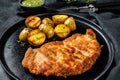 Fried Chicken schnitzel with baked potatoes. Black background. Top view Royalty Free Stock Photo