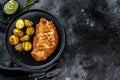Fried Chicken schnitzel with baked potatoes. Black background. Top view. Copy space Royalty Free Stock Photo