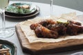 Fried chicken served on a cutting board. served christmas table. glasses with champagne. Royalty Free Stock Photo