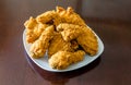 Fried Chicken in Square Plate on Polished Wood Table Royalty Free Stock Photo