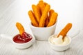 Fried chicken stick in sauce boat with ketchup, fried breaded chicken sticks in bowl, chicken stick in mayonnaise on table Royalty Free Stock Photo